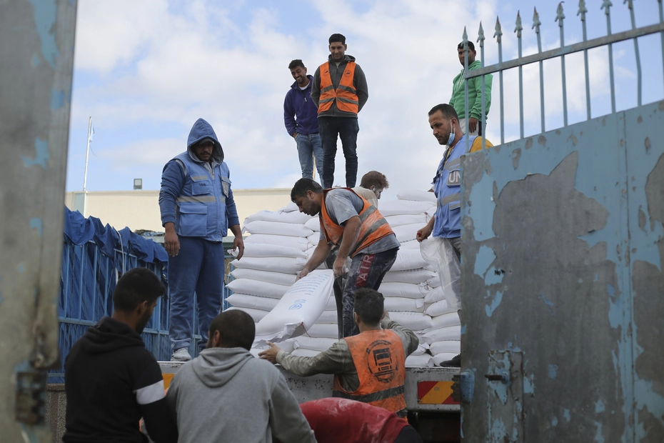 Mehlverteilung in Rafah durch UN-Helfer UN-Mitarbeitende verteilen Mehl an Palästinenser in Rafah während des anhaltenden Kriegs – Spenden unterstützen lebenswichtige Versorgung.